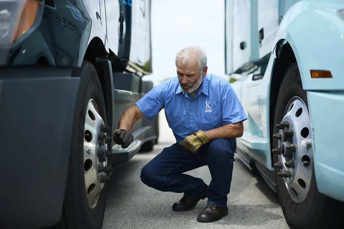 Keller Truck Driver Inspecting a Semi Truck Wheel